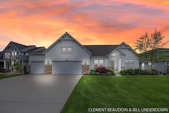 13944 Harrington Lndg, Holland, MI 49424 - view of front of house with board and batten siding, a front yard, an attached garage, driveway, and stone siding