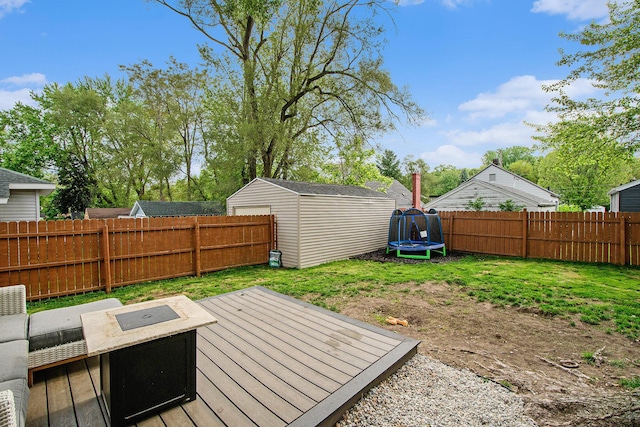 1538 Rossman Ave SE, Grand Rapids, MI 49507 - view of yard featuring a trampoline and a wooden deck