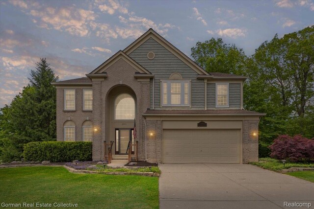 2941 Yosemite Dr, Orion, MI 48360 - view of front facade with brick siding, concrete driveway, a garage, and a front lawn