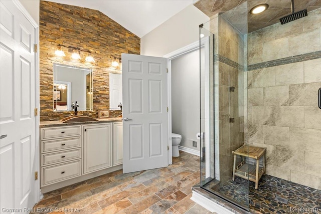 2941 Yosemite Dr, Orion, MI 48360 - bathroom with a stall shower, lofted ceiling, vanity, toilet, and stone tile flooring