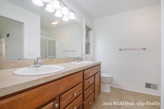 13 Foleys Grade, Lowell, MI 49331 - bathroom with double vanity, tile patterned flooring, an enclosed shower, toilet, and baseboards