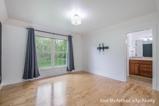 13 Foleys Grade, Lowell, MI 49331 - empty room with light wood finished floors, a sink, and baseboards