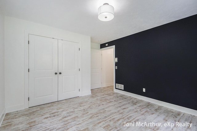 13 Foleys Grade, Lowell, MI 49331 - unfurnished bedroom with wood finished floors, a closet, and baseboards