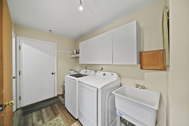 9428 Talladay Rd, Willis, MI 48191 - washroom with washer and clothes dryer, cabinet space, and wood finished floors