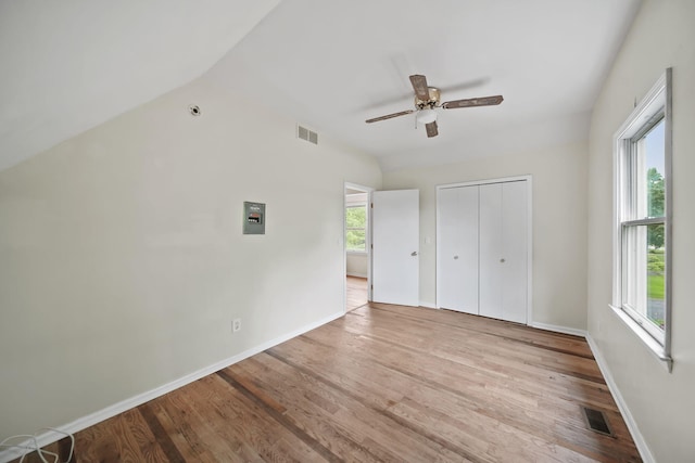 9428 Talladay Rd, Willis, MI 48191 - unfurnished bedroom with wood finished floors, a closet, baseboards, and vaulted ceiling