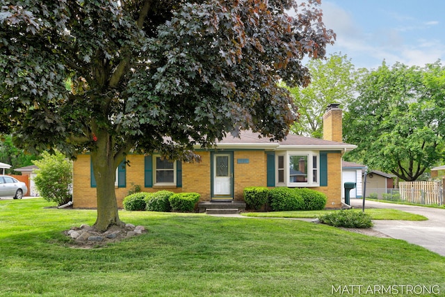 1272 Den Hertog St SW, Wyoming, MI 49509 - view of front facade featuring a chimney, brick siding, driveway, and a garage