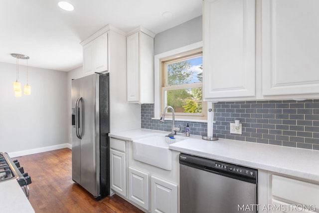 1272 Den Hertog St SW, Wyoming, MI 49509 - kitchen with appliances with stainless steel finishes, a sink, decorative backsplash, baseboards, and white cabinets