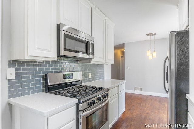 1272 Den Hertog St SW, Wyoming, MI 49509 - kitchen featuring stainless steel appliances, decorative backsplash, white cabinetry, baseboards, and dark wood-type flooring