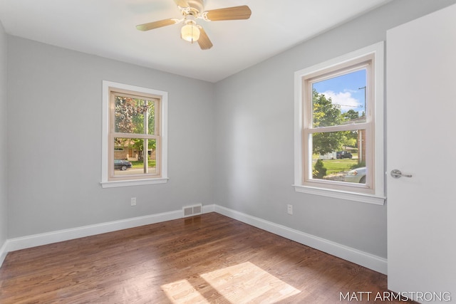 1272 Den Hertog St SW, Wyoming, MI 49509 - empty room with plenty of natural light, wood finished floors, and baseboards