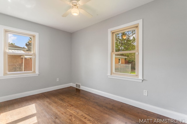 1272 Den Hertog St SW, Wyoming, MI 49509 - unfurnished room with baseboards, dark wood-style flooring, and ceiling fan