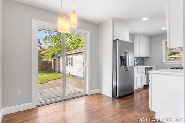 1272 Den Hertog St SW, Wyoming, MI 49509 - kitchen with stainless steel appliances, light countertops, white cabinetry, dark wood finished floors, and recessed lighting