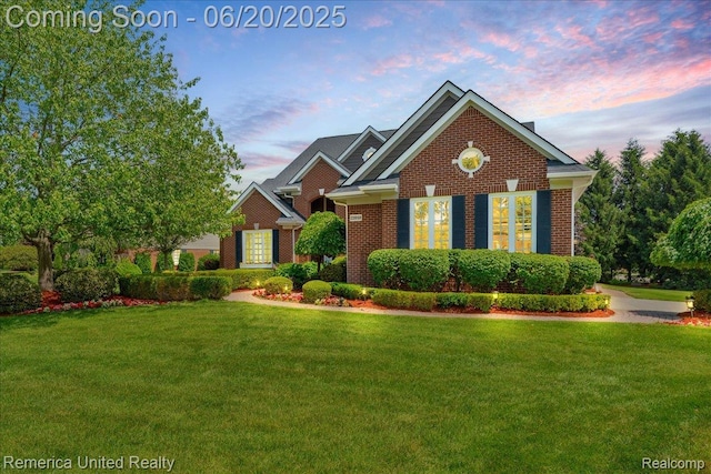 22858 Saint George Cir S, Lyon, MI 48178 - view of front facade featuring a lawn and brick siding