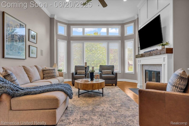 22858 Saint George Cir S, Lyon, MI 48178 - living room featuring a fireplace with flush hearth, crown molding, ceiling fan, and wood finished floors