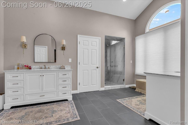 22858 Saint George Cir S, Lyon, MI 48178 - full bathroom featuring a shower stall, vanity, vaulted ceiling, and tile patterned flooring