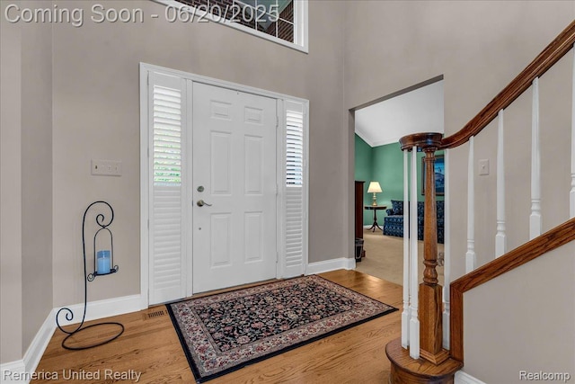 22858 Saint George Cir S, Lyon, MI 48178 - foyer entrance with wood finished floors, stairway, and a high ceiling