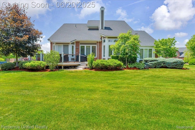 22858 Saint George Cir S, Lyon, MI 48178 - back of house with a wooden deck, a lawn, a chimney, and brick siding