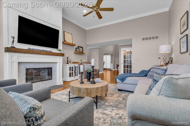 22858 Saint George Cir S, Lyon, MI 48178 - living room featuring ornamental molding, a ceiling fan, wood finished floors, a tile fireplace, and recessed lighting