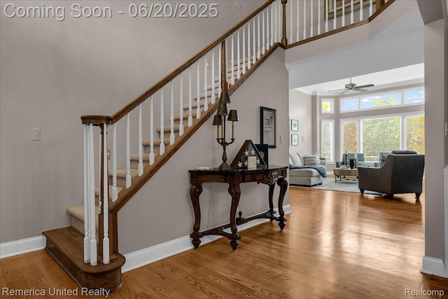 22858 Saint George Cir S, Lyon, MI 48178 - stairway featuring a high ceiling, wood finished floors, and a ceiling fan