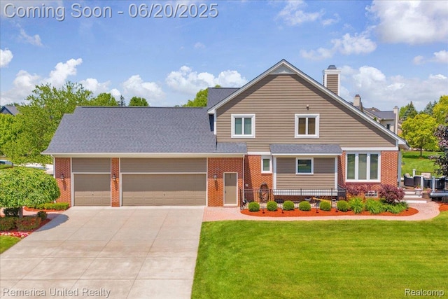 22858 Saint George Cir S, Lyon, MI 48178 - view of front of home with brick siding, driveway, an attached garage, and a front yard