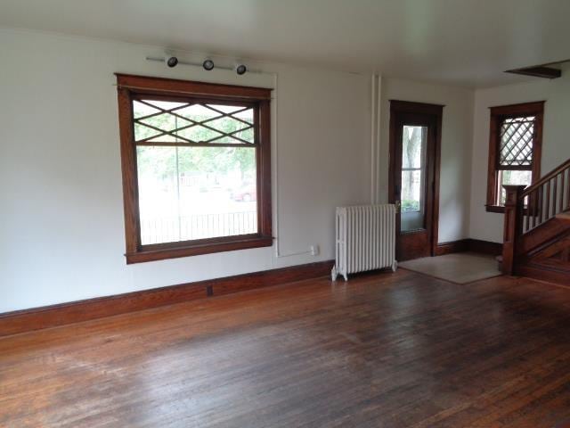 510 S Main, Mount Pleasant, MI 48858 - foyer entrance featuring radiator heating unit, dark wood-style flooring, baseboards, and stairway