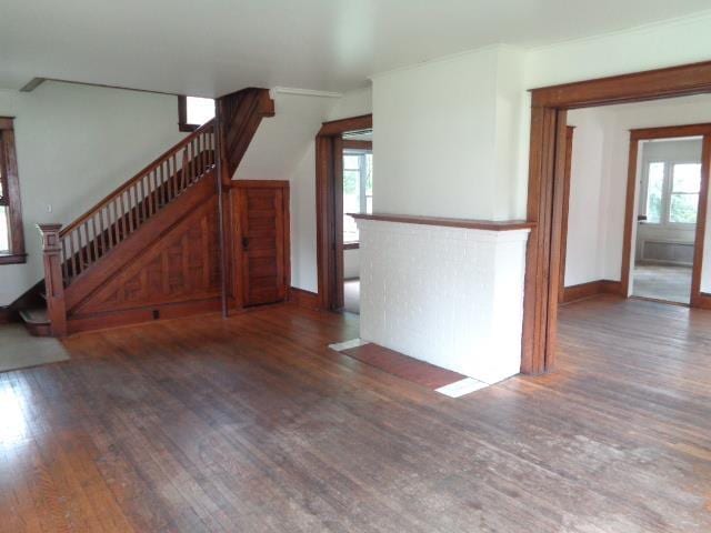 510 S Main, Mount Pleasant, MI 48858 - unfurnished living room with wood finished floors, stairway, and baseboards