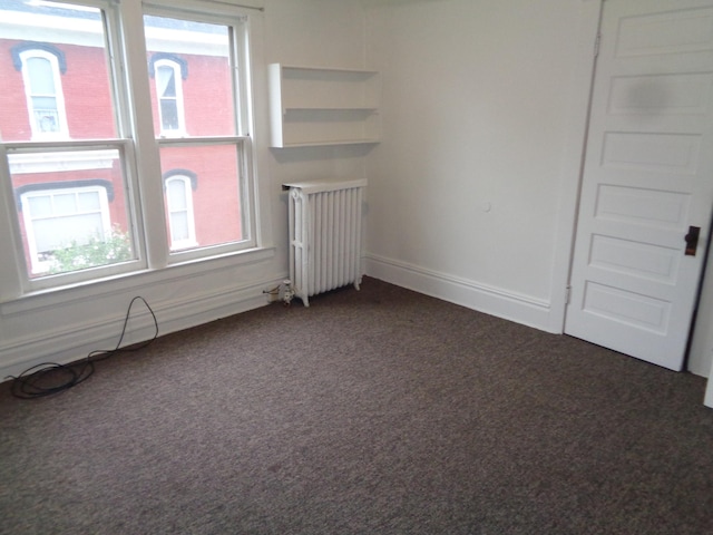 510 S Main, Mount Pleasant, MI 48858 - spare room with radiator heating unit, dark colored carpet, and baseboards