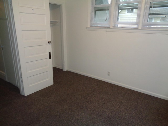 510 S Main, Mount Pleasant, MI 48858 - unfurnished bedroom featuring dark carpet and baseboards