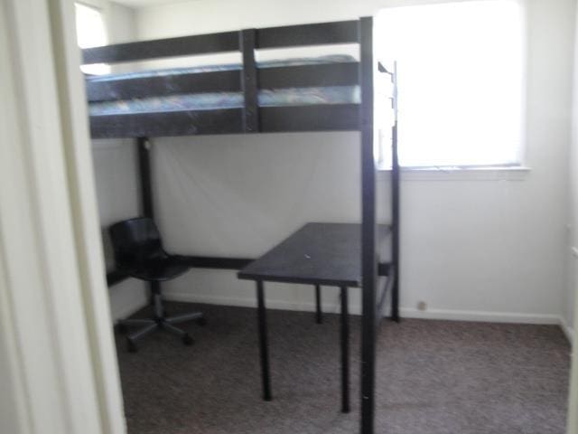 510 S Main, Mount Pleasant, MI 48858 - carpeted bedroom with multiple windows and baseboards