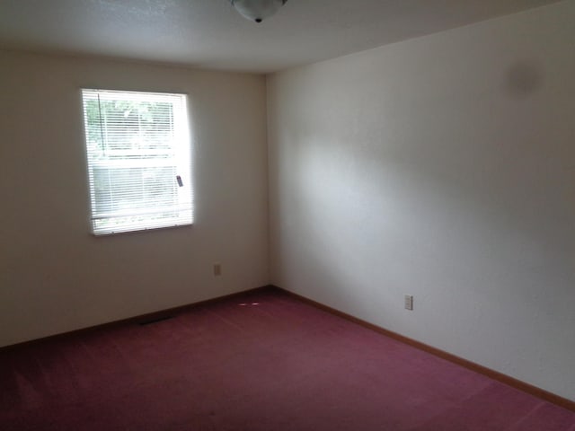 1014 S Lansing, Mount Pleasant, MI 48858 - spare room with dark colored carpet and baseboards