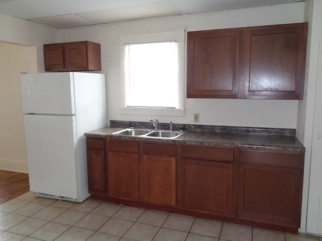 1014 S Lansing, Mount Pleasant, MI 48858 - kitchen featuring freestanding refrigerator, a sink, dark countertops, and brown cabinets