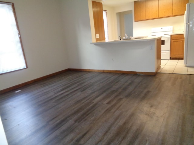 1020 S Lansing, Mount Pleasant, MI 48858 - kitchen featuring white appliances, light countertops, light wood finished floors, and baseboards