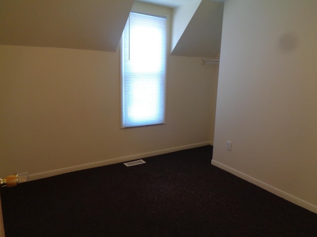 1020 S Lansing, Mount Pleasant, MI 48858 - bonus room featuring lofted ceiling, baseboards, and dark colored carpet