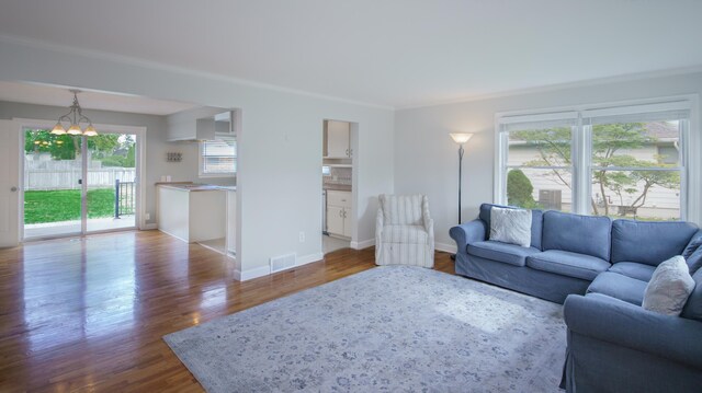 2720 Willa Dr, Saint Joseph, MI 49085 - living area featuring wood finished floors, ornamental molding, a chandelier, and baseboards