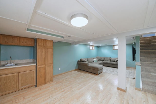 2720 Willa Dr, Saint Joseph, MI 49085 - living area with light wood-style floors, stairway, bar with sink, and baseboards