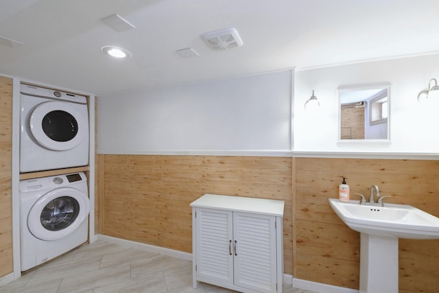 2720 Willa Dr, Saint Joseph, MI 49085 - laundry area featuring stacked washer / drying machine, wood walls, and baseboards