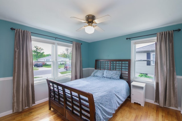2720 Willa Dr, Saint Joseph, MI 49085 - bedroom with multiple windows, wood finished floors, and baseboards