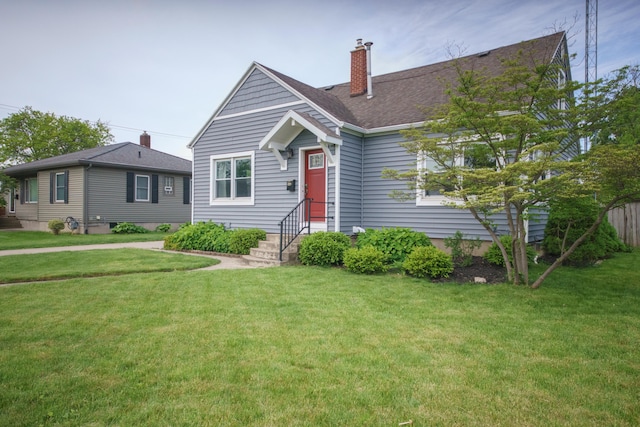 2720 Willa Dr, Saint Joseph, MI 49085 - view of front facade featuring a front yard and a chimney