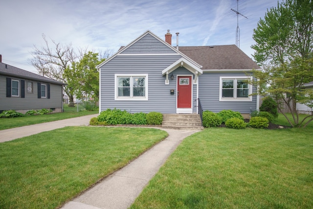 2720 Willa Dr, Saint Joseph, MI 49085 - bungalow-style home with a front yard, a chimney, and a shingled roof