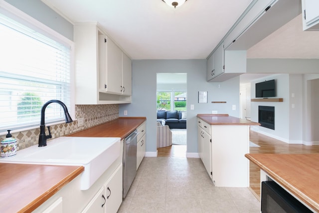 2720 Willa Dr, Saint Joseph, MI 49085 - kitchen with dishwasher, a sink, decorative backsplash, a fireplace, and open floor plan