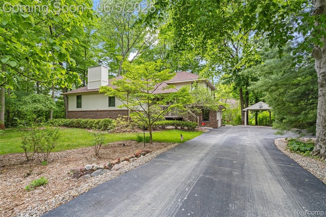29915 Ardmore Dr, Farmington, MI 48334 - view of front of home with brick siding, a chimney, and a front lawn