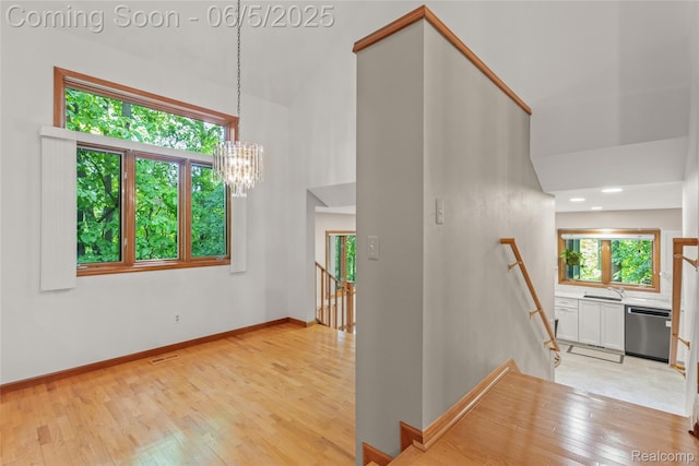 29915 Ardmore Dr, Farmington, MI 48334 - stairs featuring wood-type flooring, a chandelier, a high ceiling, baseboards, and recessed lighting