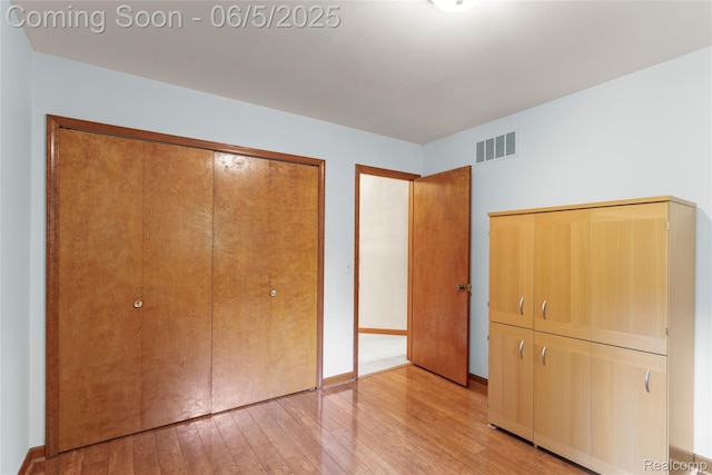 29915 Ardmore Dr, Farmington, MI 48334 - unfurnished bedroom featuring a closet, light wood-style floors, and baseboards