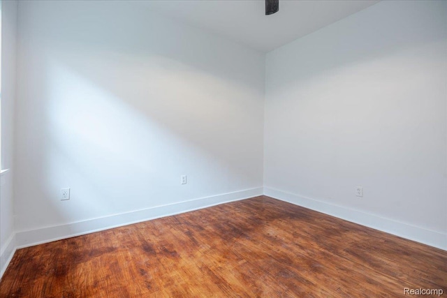 2270 W Philadelphia St, Detroit, MI 48206 - spare room with baseboards and dark wood-type flooring