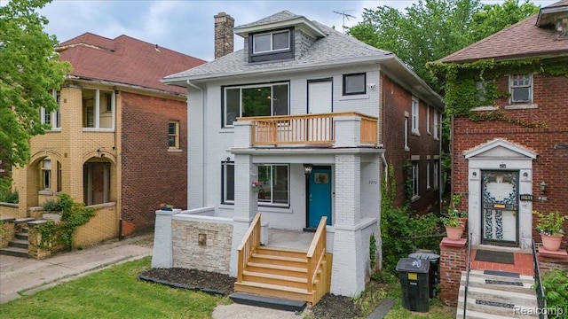 2270 W Philadelphia St, Detroit, MI 48206 - view of front of house featuring a balcony, brick siding, a chimney, and a shingled roof
