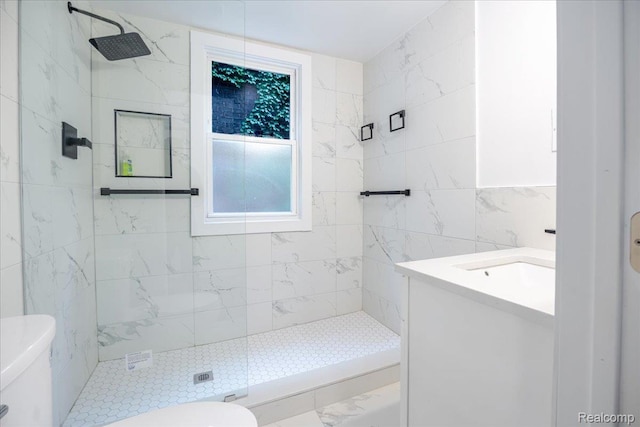 2270 W Philadelphia St, Detroit, MI 48206 - bathroom with toilet, tiled shower, vanity, and tile walls