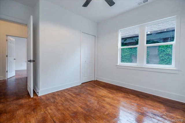 2270 W Philadelphia St, Detroit, MI 48206 - unfurnished bedroom featuring wood finished floors, baseboards, a closet, and a ceiling fan