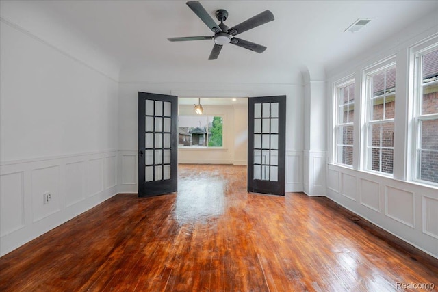 2270 W Philadelphia St, Detroit, MI 48206 - unfurnished room with french doors, a decorative wall, wood finished floors, a wainscoted wall, and ceiling fan