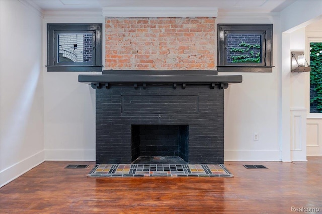 2270 W Philadelphia St, Detroit, MI 48206 - detailed view of baseboards, wood finished floors, ornamental molding, and a fireplace