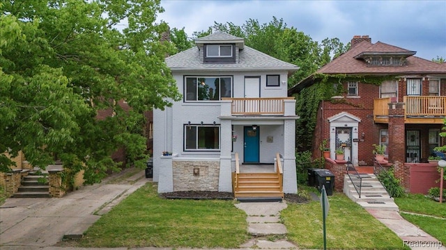 2270 W Philadelphia St, Detroit, MI 48206 - traditional style home with a balcony, a front lawn, and brick siding