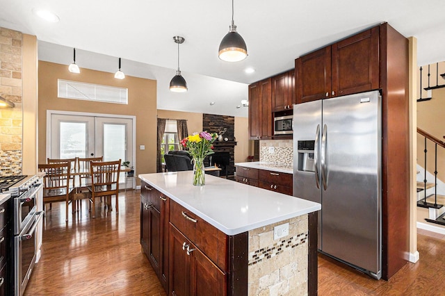 764 Allen Rd, Milan, MI 48160 - kitchen with stainless steel appliances, wood finished floors, decorative backsplash, and light countertops